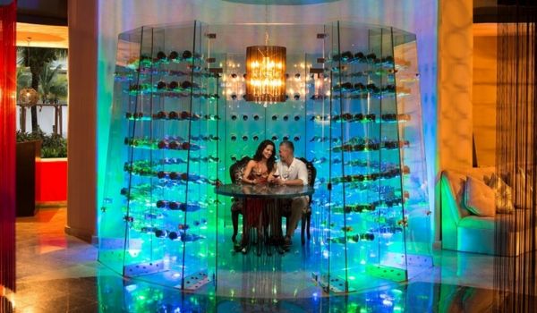 Couple dining in a lit-up romantic wine cellar