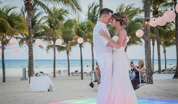 Bride and groom dancing on the beach