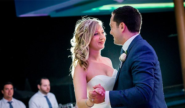 Bride and groom dancing at night