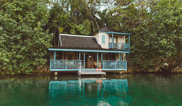 House overloooking a river surrounded by lush tropical forest