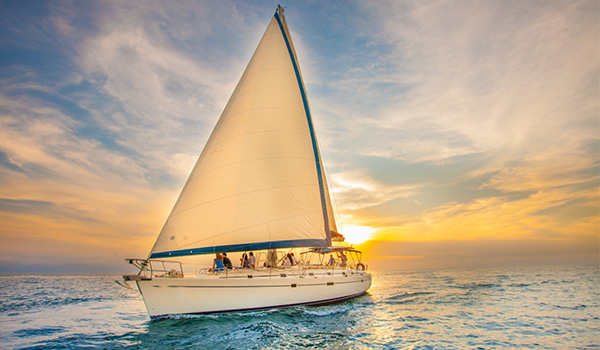A luxurious sailboat at sunset