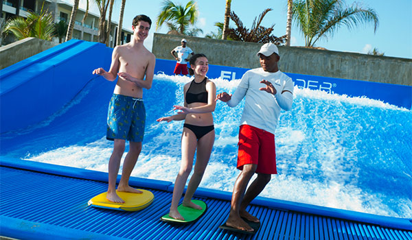 Instructor teaching children how to ride the FlowRider