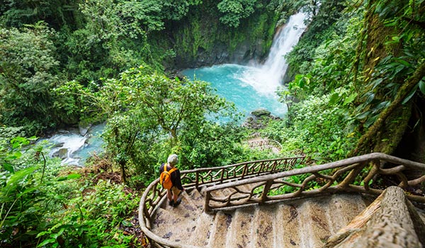Staircase in the middle of the jungle leading to beautiful waterfall