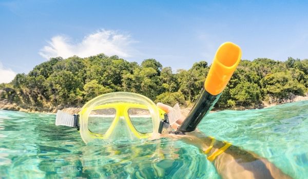 Snorkel mask in crystal-clear water