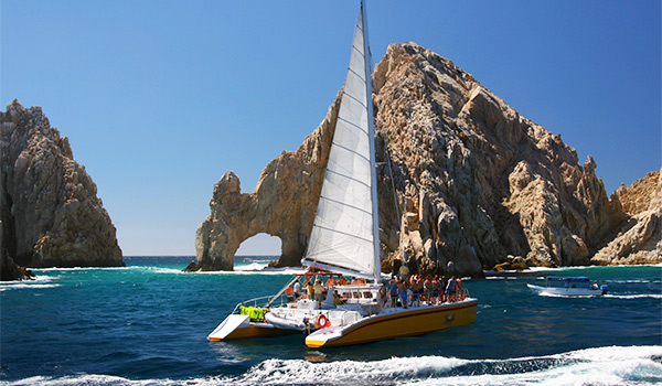 Catamaran sailing by the famous arch of Los Cabos