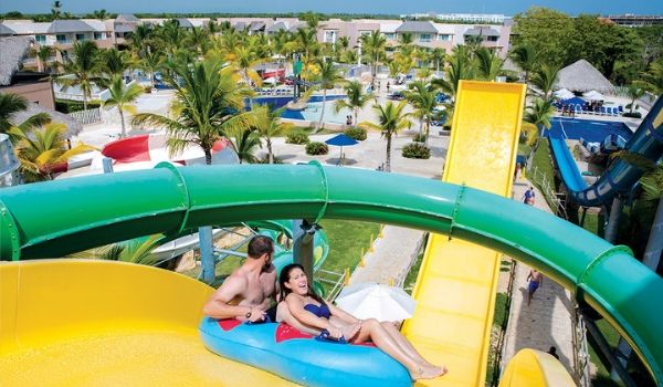 Man and woman going down water slide