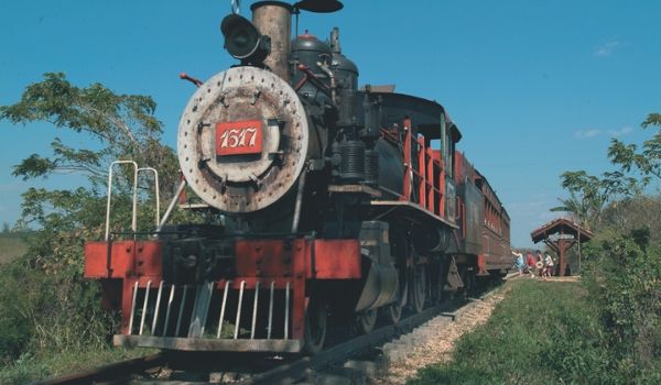 Old steam train riding through the countryside