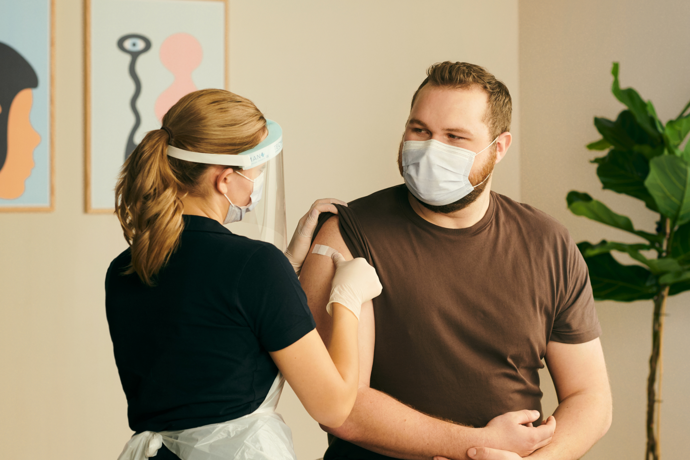 Man getting vaccinated against covid-19 by nurse