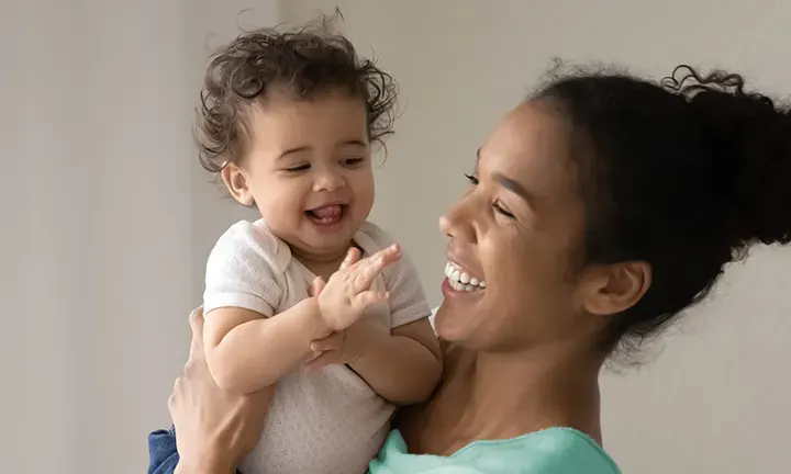 Banner image of a baby and mom laughing