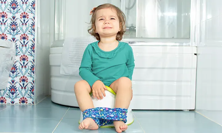 Banner image of a baby during potty training for the article how to Deal with Potty Training Regression