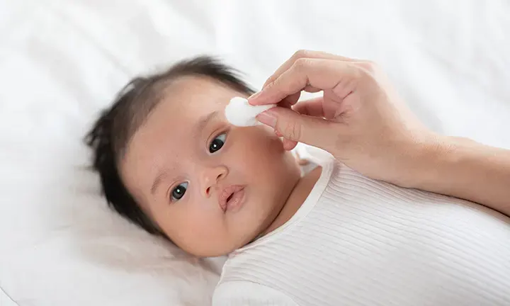 Cleaning baby’s face eyes ears nose