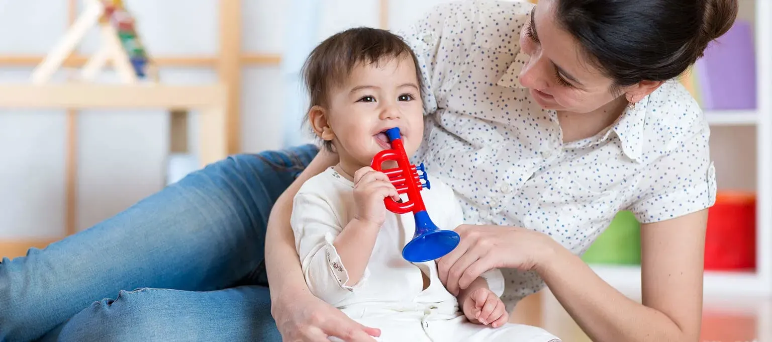 A stay-at-home mom plays with her baby