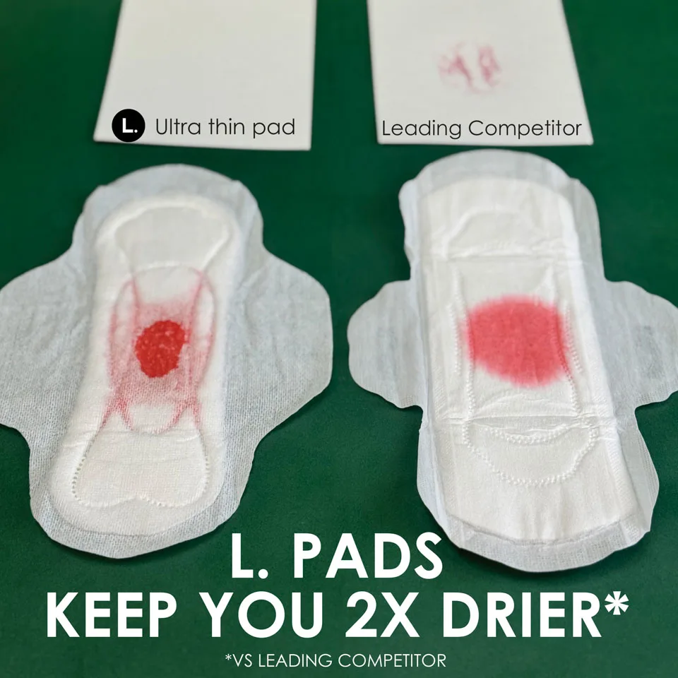 Closeup of L. pad absorbing red liquid highlighting the channels of the pads. Powerful leak stopping design, all day leak protection