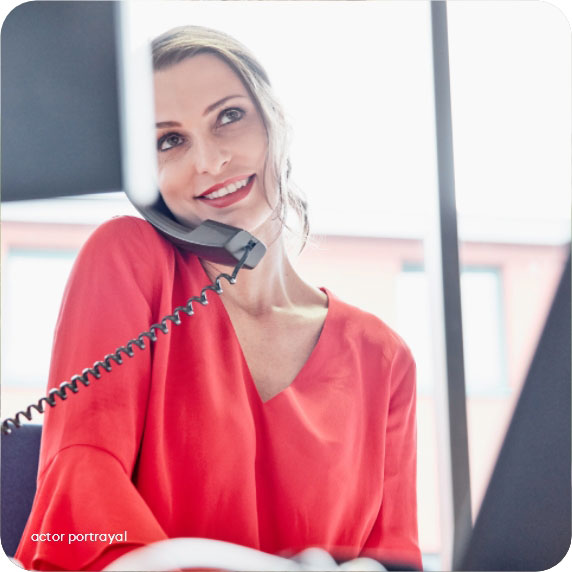 Actor portrayal of a smiling woman talking on the phone