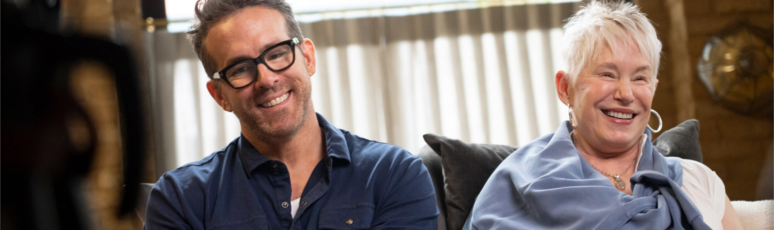 Ryan Reynolds smiling with his mother during an interview