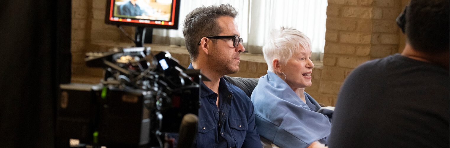 Behind the scenes view of Ryan Reynolds with his mother during an interview.