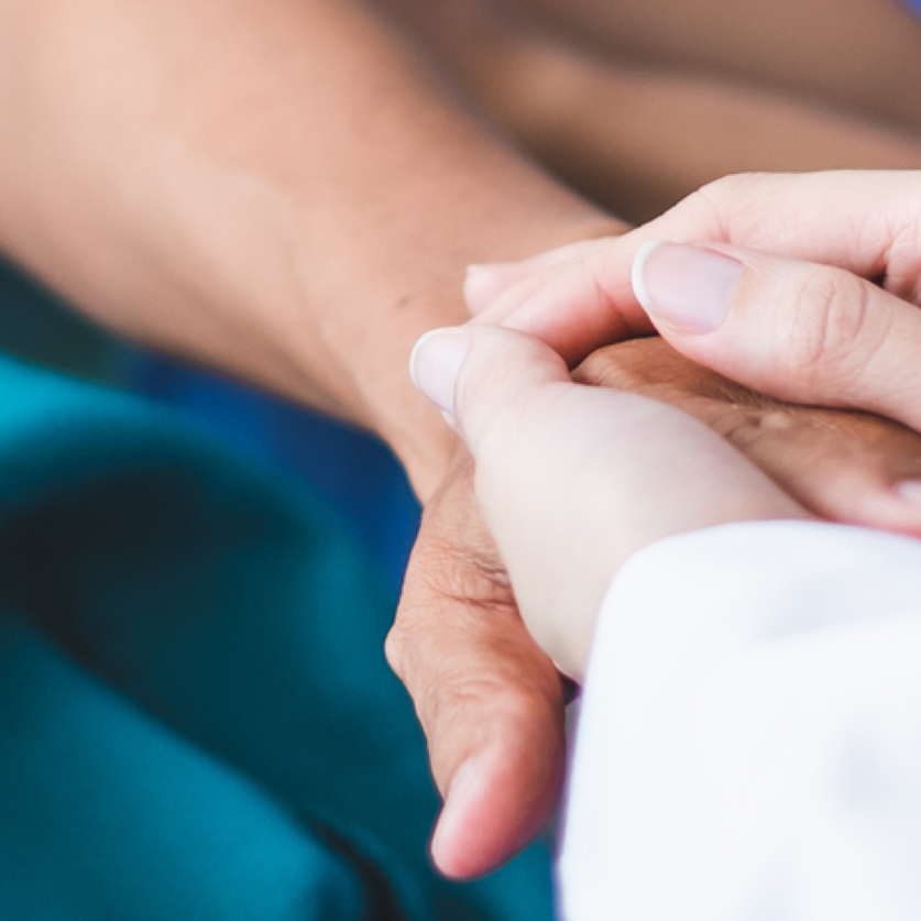 Holding another's hand to provide comfort