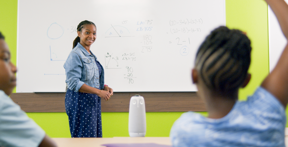 Teacher engaging with students in classroom with Meeting Owl Technology