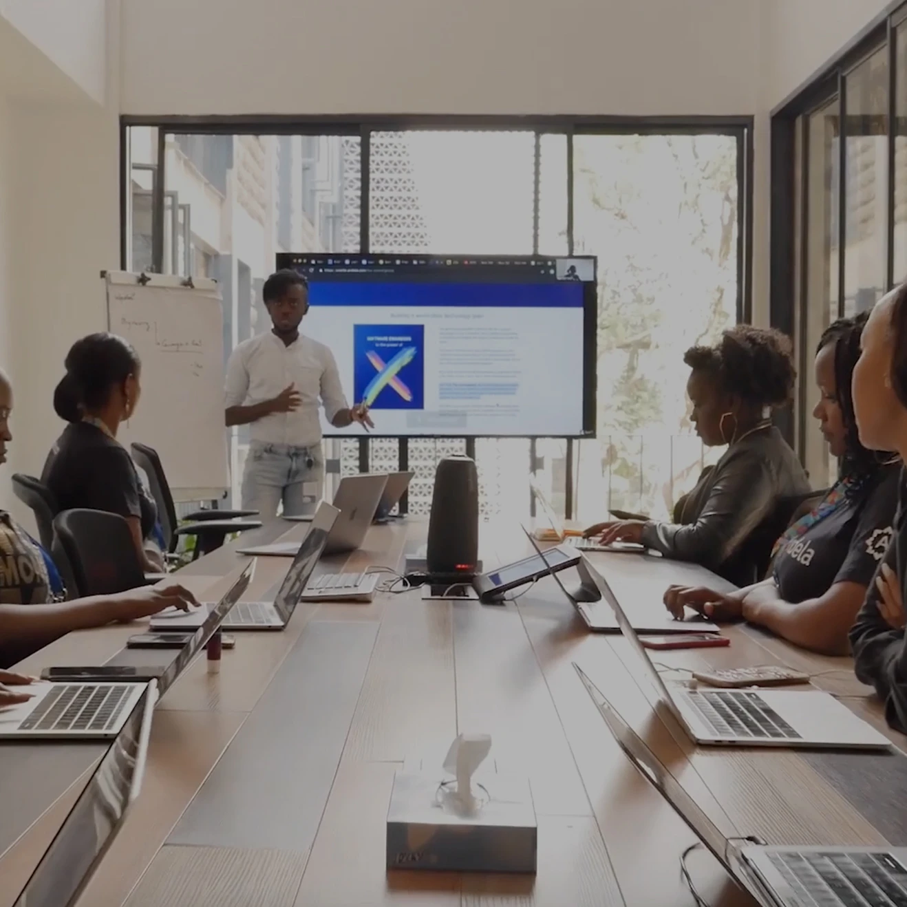 Andela using a Meeting Owl conferencing device in meeting
