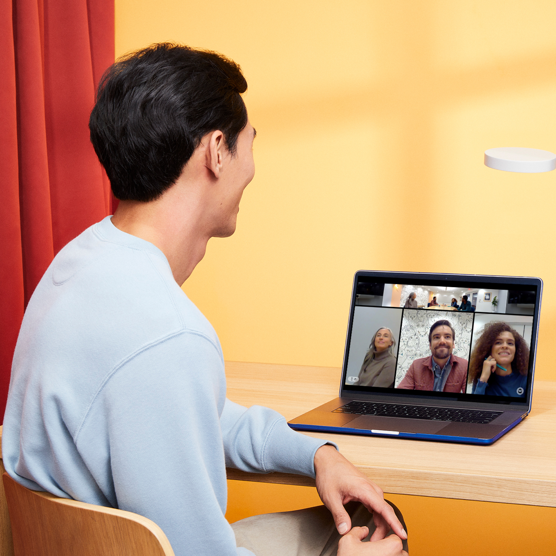 Man enjoying hybrid meeting remotely with Meeting Owl technology