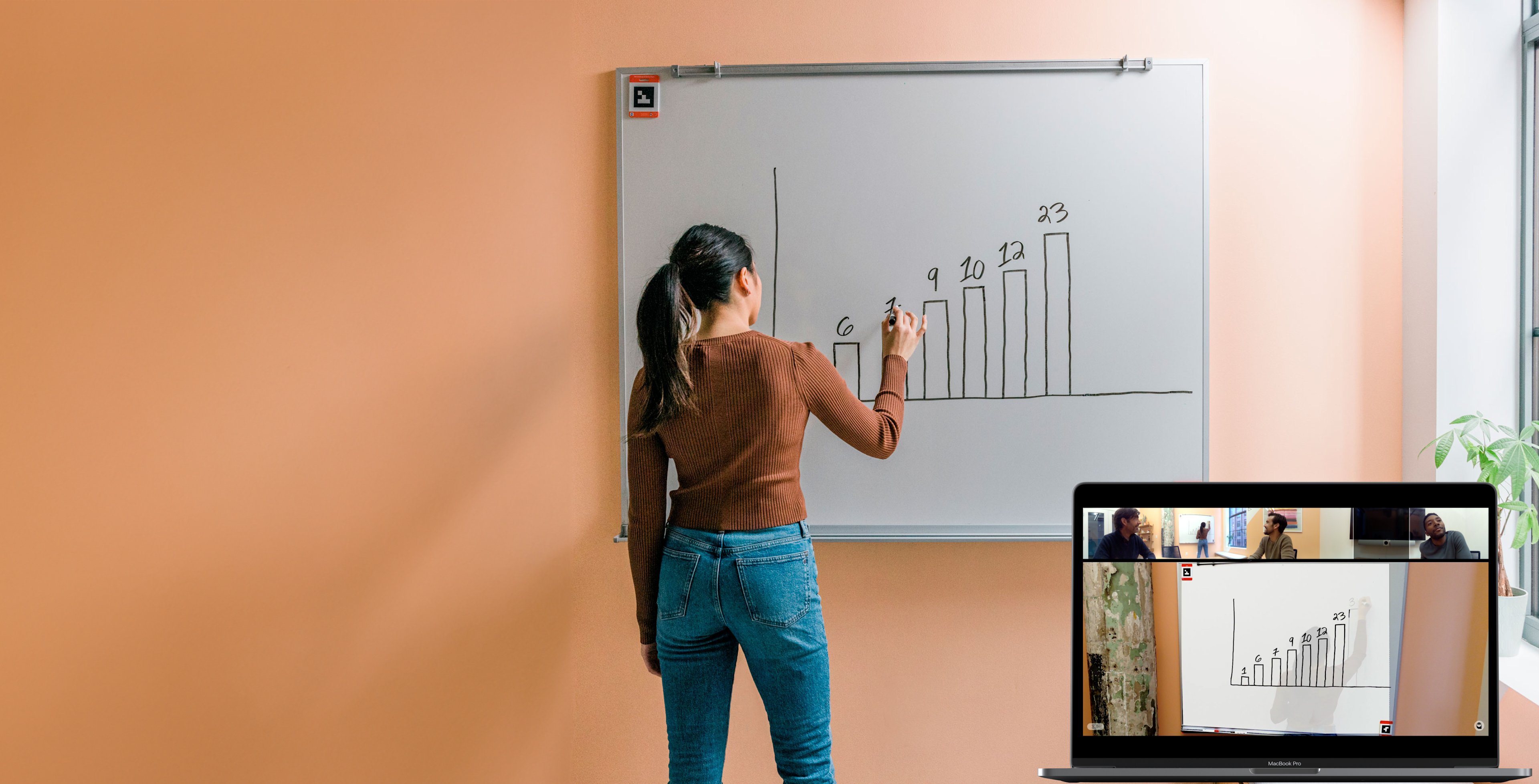 Instructor writing on Whiteboard using Whiteboard Owl technology for hybrid education on laptop