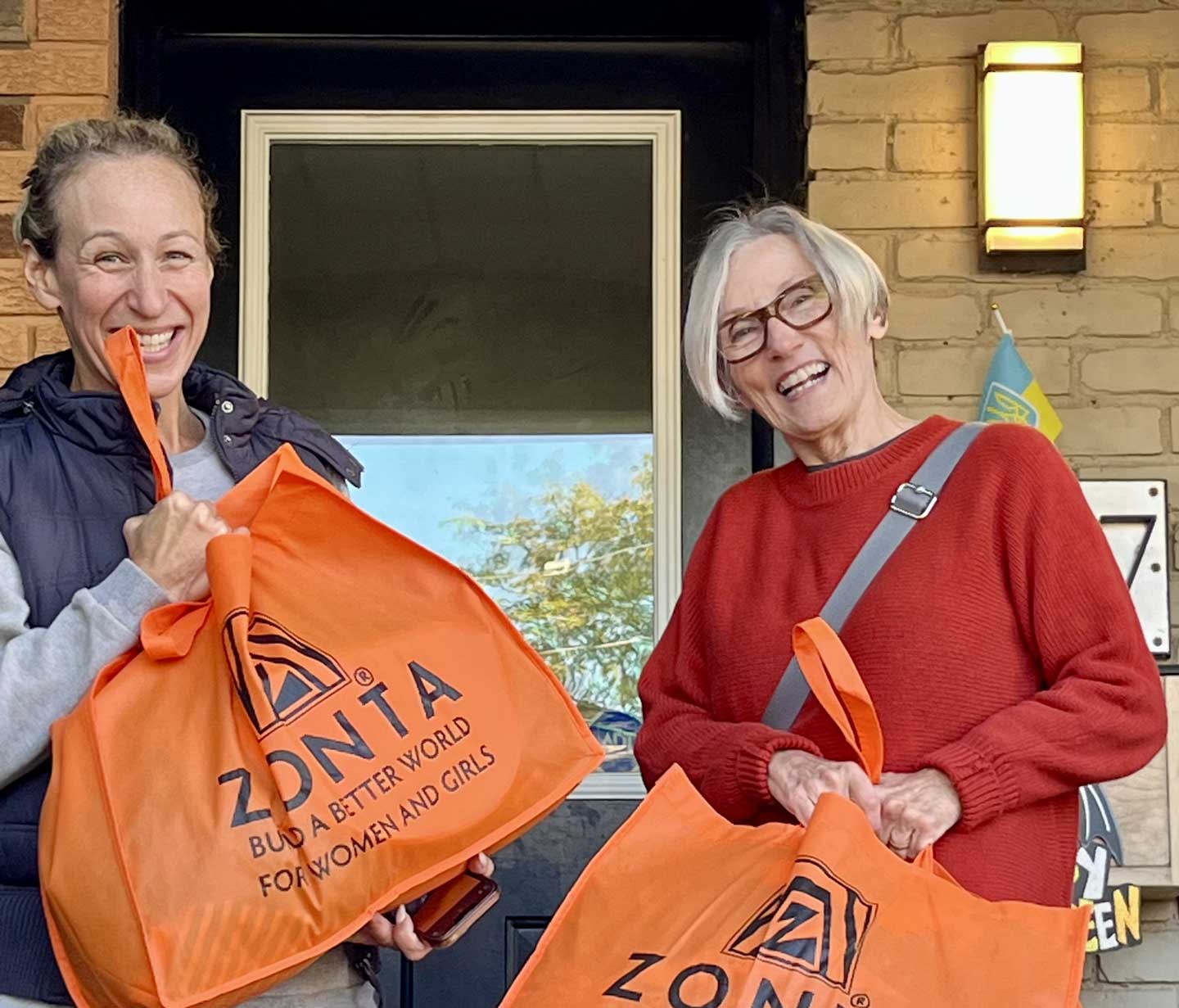 Zonta Members Proudly showing Orange Bags