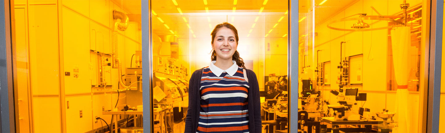 Photo of a woman standing in front of a laboratory