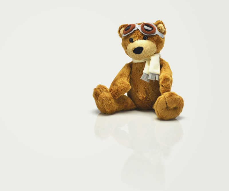 Photo of a teddy bear dressed as a pilot by Barrett Ward via Unsplash