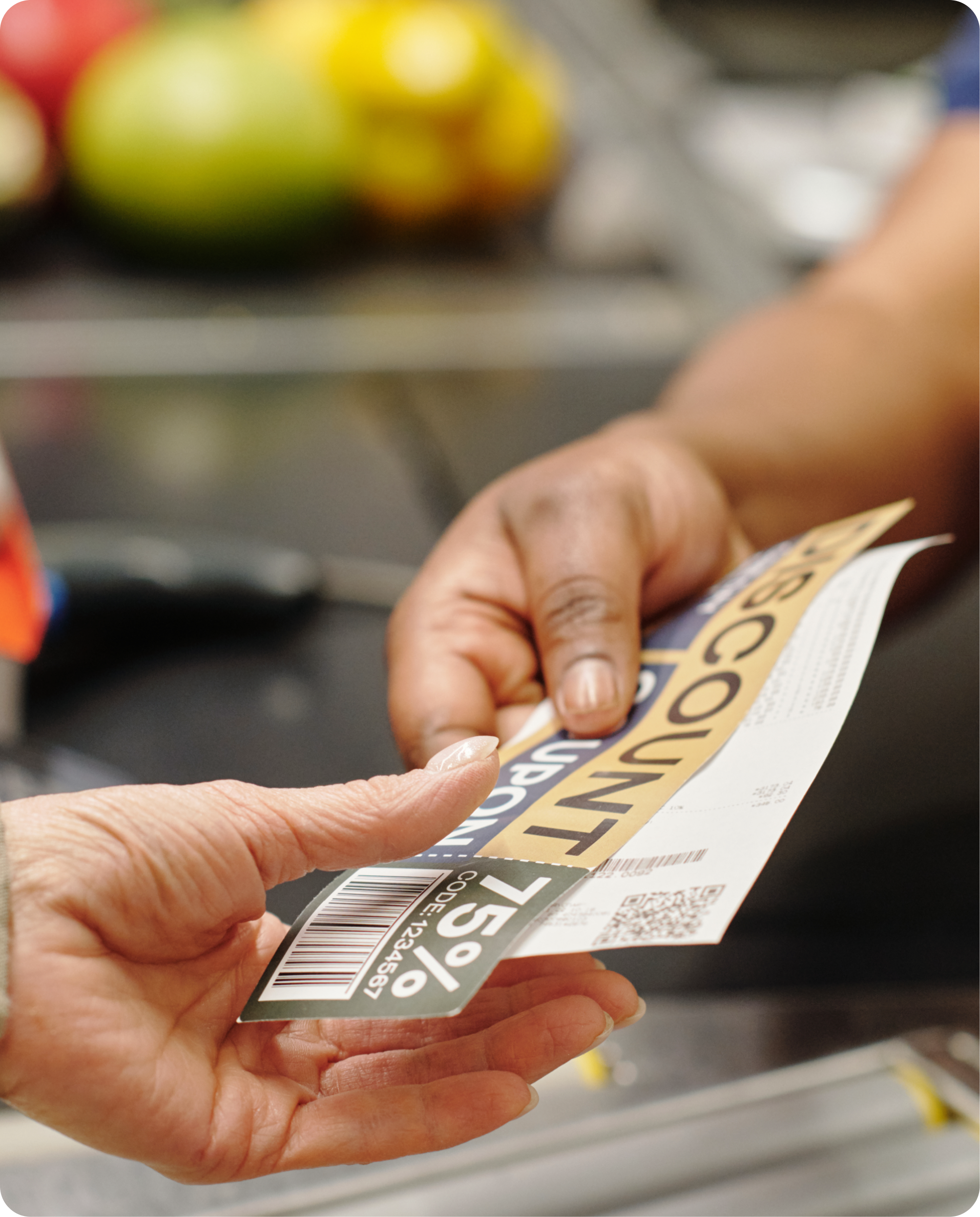 Close-up photo of a woman handing coupons to a cashier