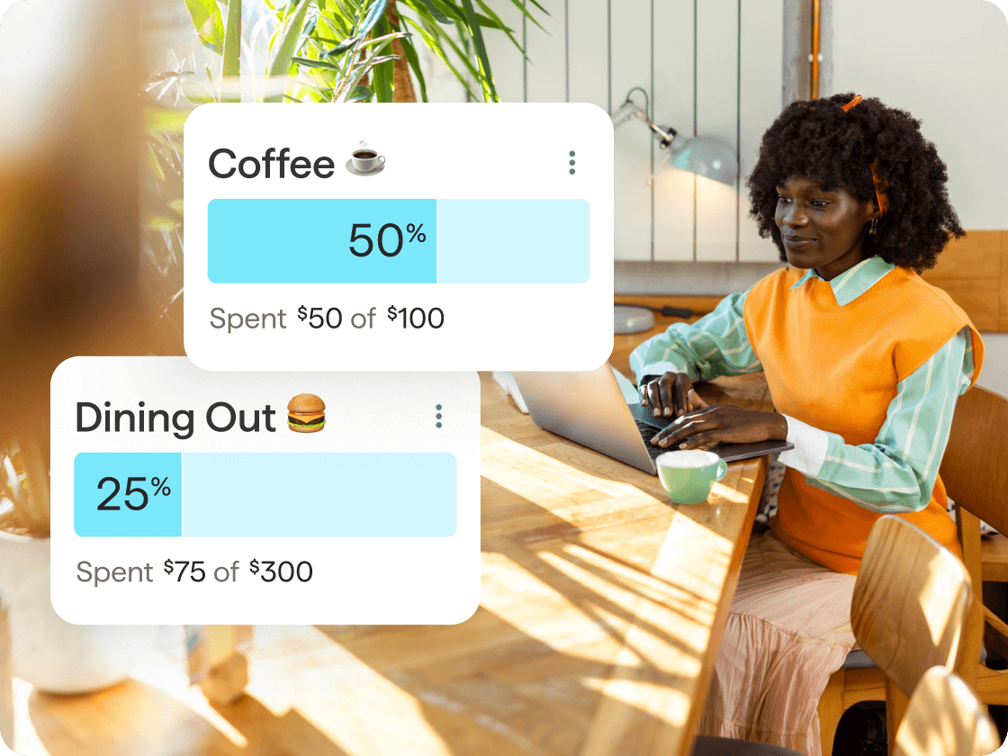 A woman works on a laptop at a sunlit table. Overlaid budgeting cards show spending progress for Coffee at 50% and Dining Out at 25%, with amounts spent toward each budget.