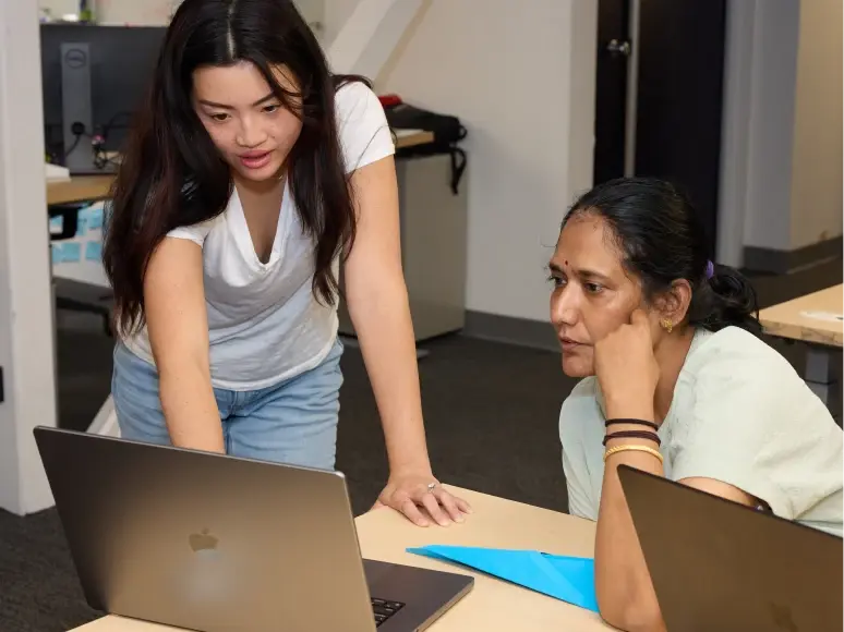 Colleagues working together at a desk in the office