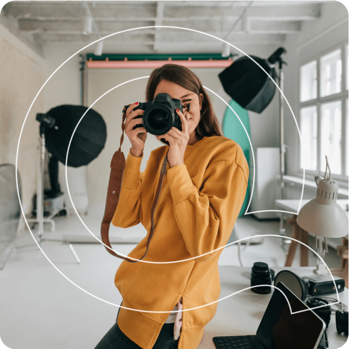 A young women is happily capturing a picture on a moment.