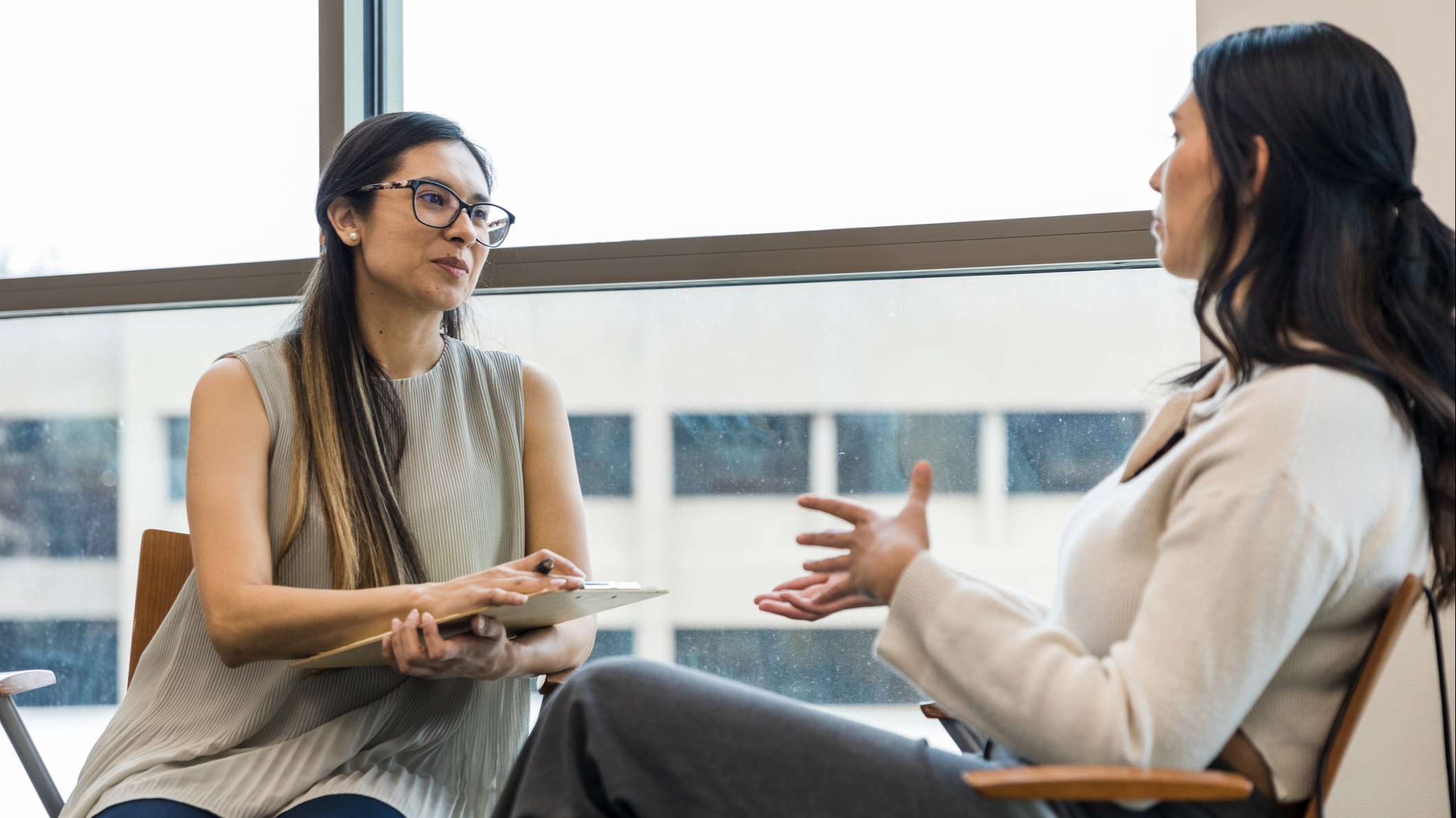 A brain health coach listens empathetically to young client.