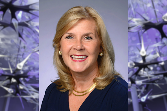Jane Wigginton, MD Hero with BPI neuron sculpture in purple light. Chief Medical Advisor.