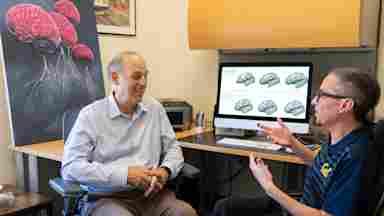 Dr. Mark D’Esposito (left) and Kevin Weiner discussing Weiner’s research on grooves and folds in the human brain and how they relate to cognitive function and a healthy brain. Photo Credit: Brandon Sanchez Mejia for UC Berkeley.