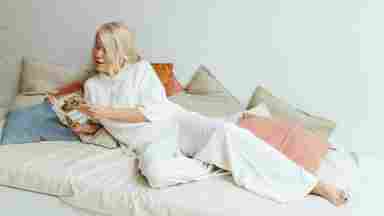 Senior woman reading a book in a peaceful room.