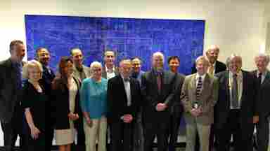 Group photo taken at the 2014 Reprogramming the Brain to Health symposium, hosted by Center for BrainHealth. 15 individuals are standing together.