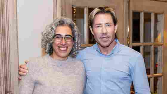 Sleep scientists Eti Ben Simon, PhD, and Matt Walker, PhD, pose for a photo at a warmly lit reception, celebrating the launch of the Sleep Innovation Laboratories at Center for BrainHealth, part of UT Dallas.