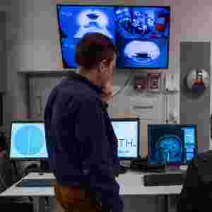 Over the shoulder shot of Sergey (left) and Jason (right) in the MRI command center