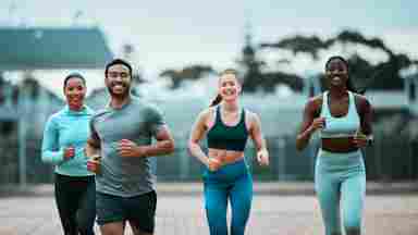 A group of friends smiling and working out together.