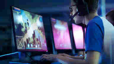 A gamer boy is playing games on the PC. teen computer gaming Charisma