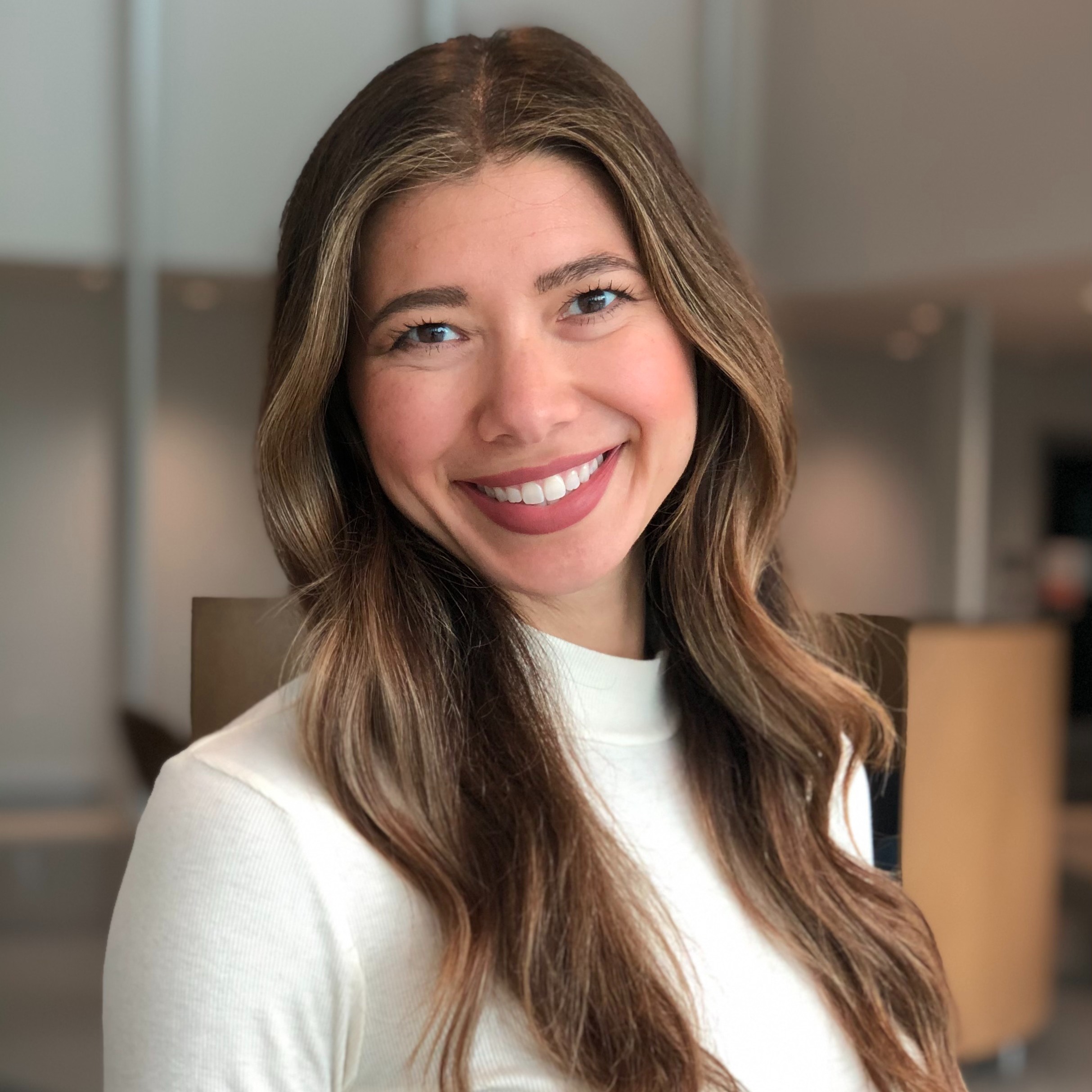 Julie Fratantoni is wearing a white sweater with a plain background. portrait. Close-up. Head of Operations, The BrainHealth Project, Research Scientist, BrainHealth Research.