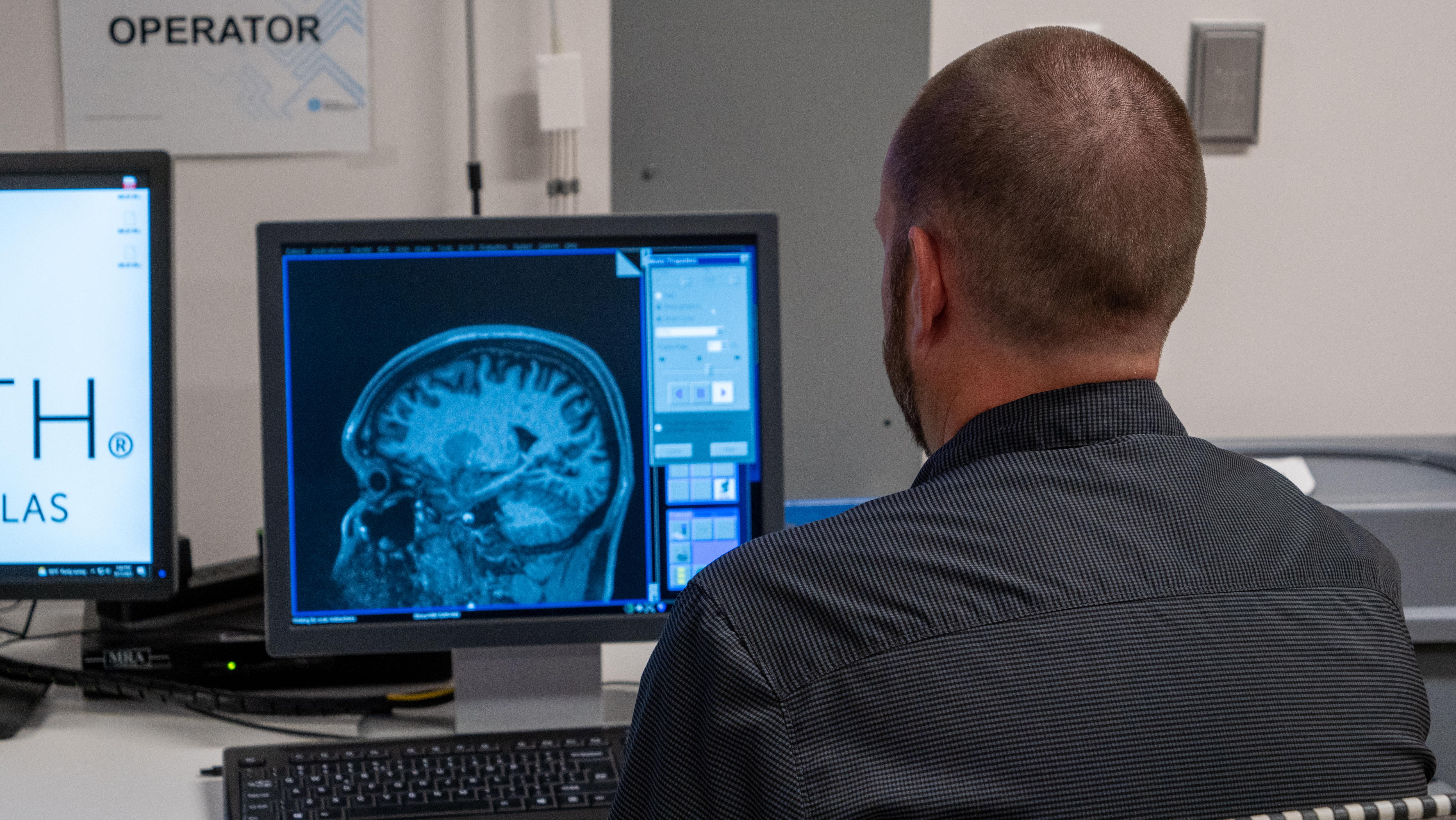 Over the shoulder shot of Jason reviewing a brain scan, MRI, Imaging Center