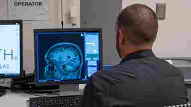 Over the shoulder shot of Jason reviewing a brain scan, MRI, Imaging Center