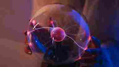 Magnetic ball in women of color's hands.