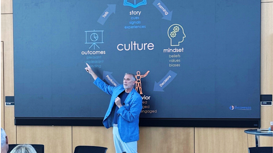 Tony Bridwell, PhD, speaks about mindset and culture, pictured in front of a large presentation screen at Center for BrainHealth in Dallas, Texas.