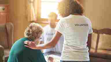 Volunteers work on activities with residents at a retirement home.