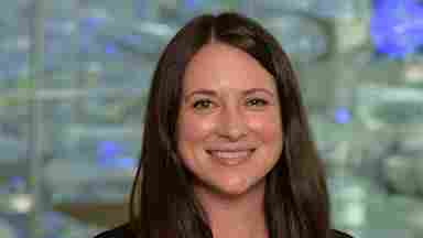 Jillian Hill is wearing a black blazer with blue lights, portrait. Clinician.