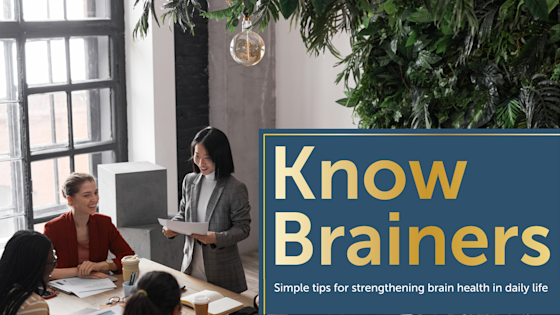 Diverse business team works in well-lit conference room created using biophilic design.