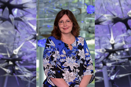 Maria Johnson, MA, CCC-SLP Hero with BPI neuron sculpture in purple light. Director, Youth & Family Innovations Lead Research Clinician and Trainer, Charisma Virtual Social Training.